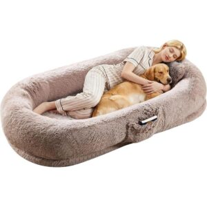 Orthopedic dog bed with plush faux fur, showing a woman comfortably resting beside her dog on a large supportive pet bed.